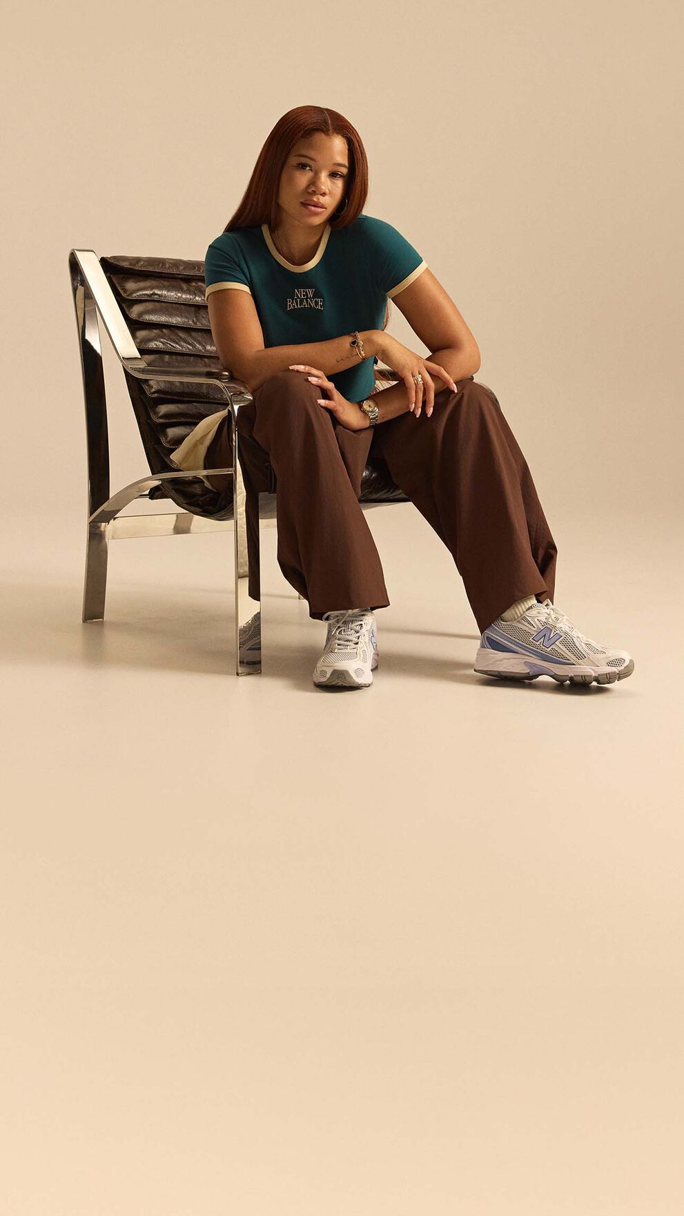 Storm Reid sitting on a chair with the 740 shoes on 